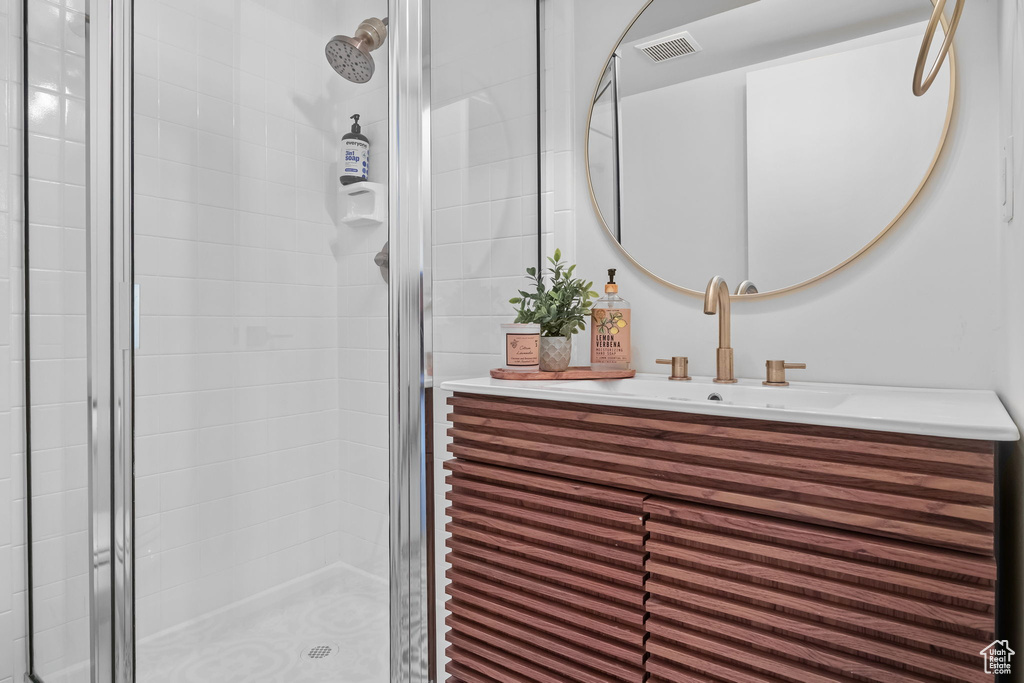 Bathroom with a shower stall and vanity
