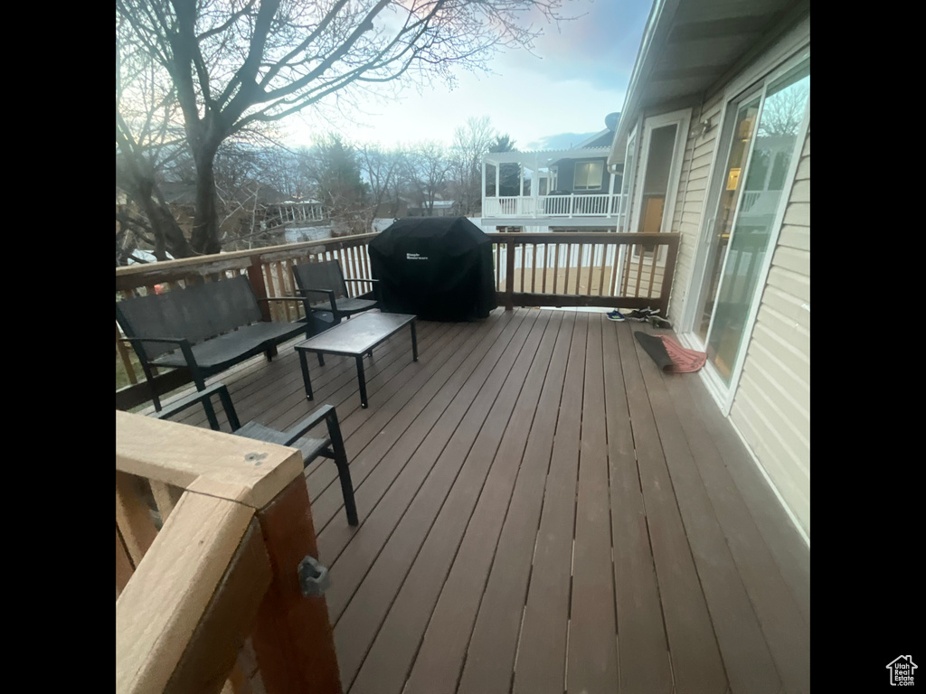 Wooden terrace featuring grilling area