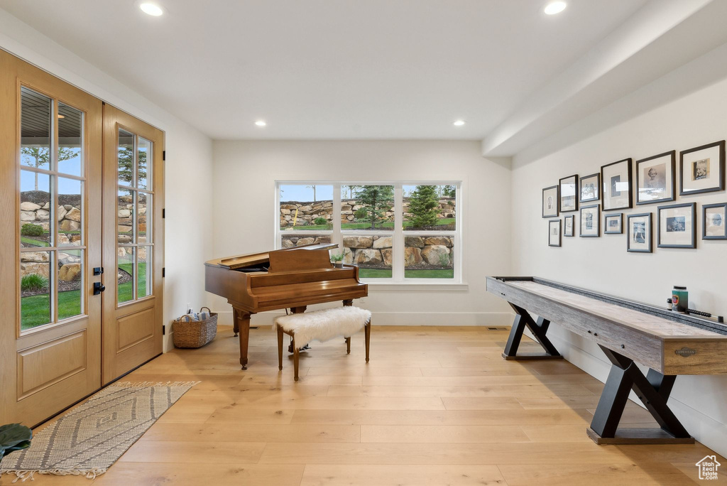 Foyer entrance featuring recessed lighting, plenty of natural light, light wood-style floors, and french doors