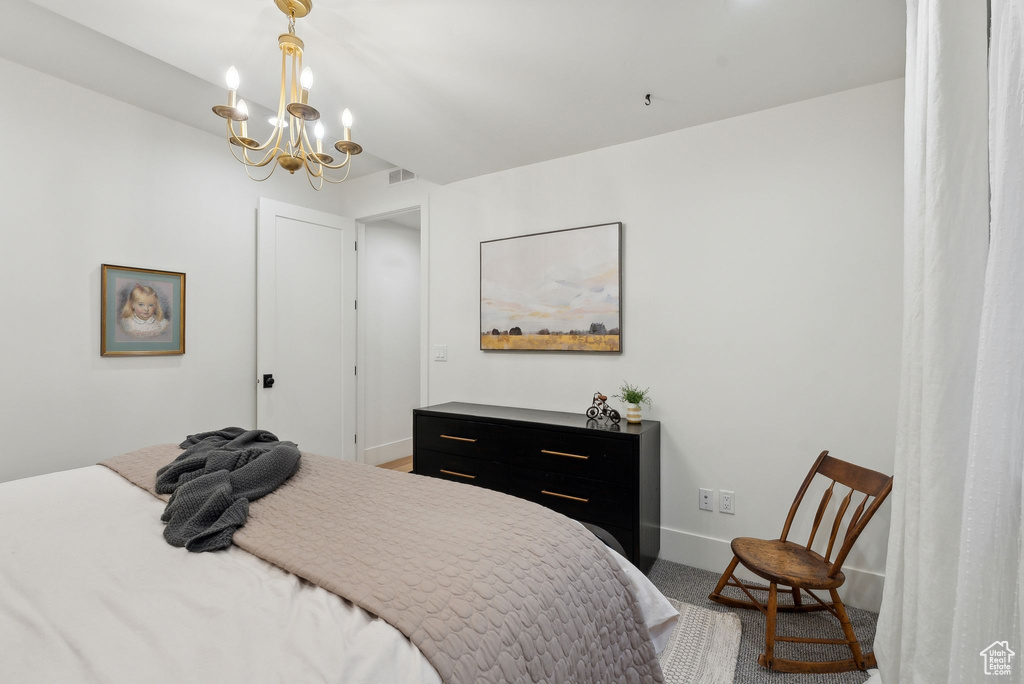Bedroom featuring baseboards, a chandelier, and carpet floors
