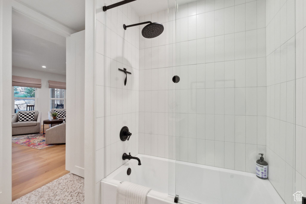 Bathroom featuring shower / bath combination, recessed lighting, and wood finished floors