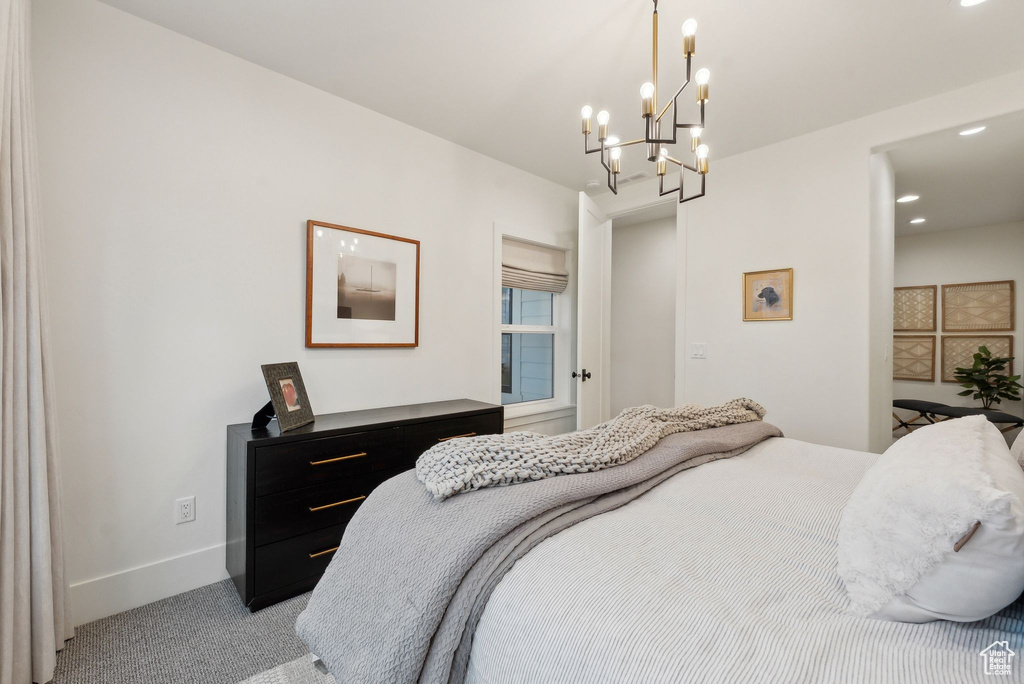 Bedroom with light carpet, a chandelier, baseboards, and recessed lighting
