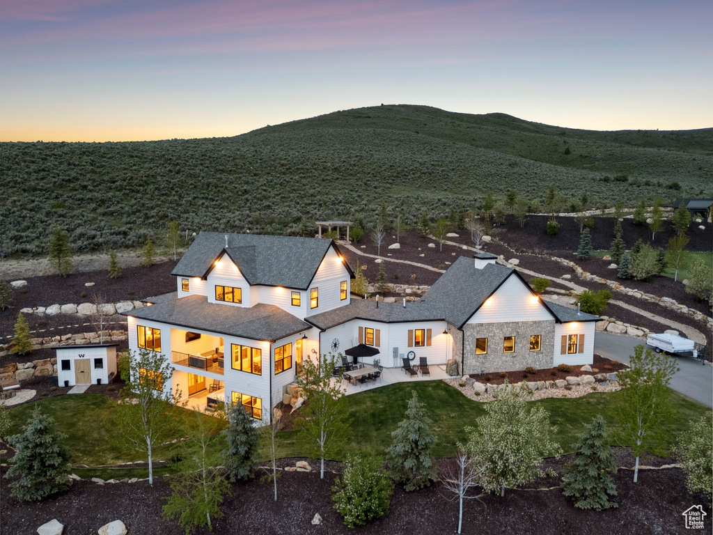 Aerial view of property and surrounding area with a mountain backdrop