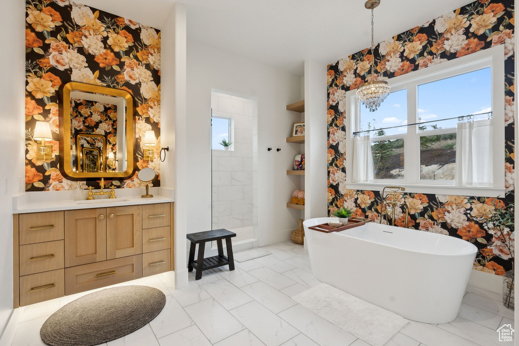 Bathroom featuring wallpapered walls, a chandelier, marble finish floors, plenty of natural light, and a walk in shower