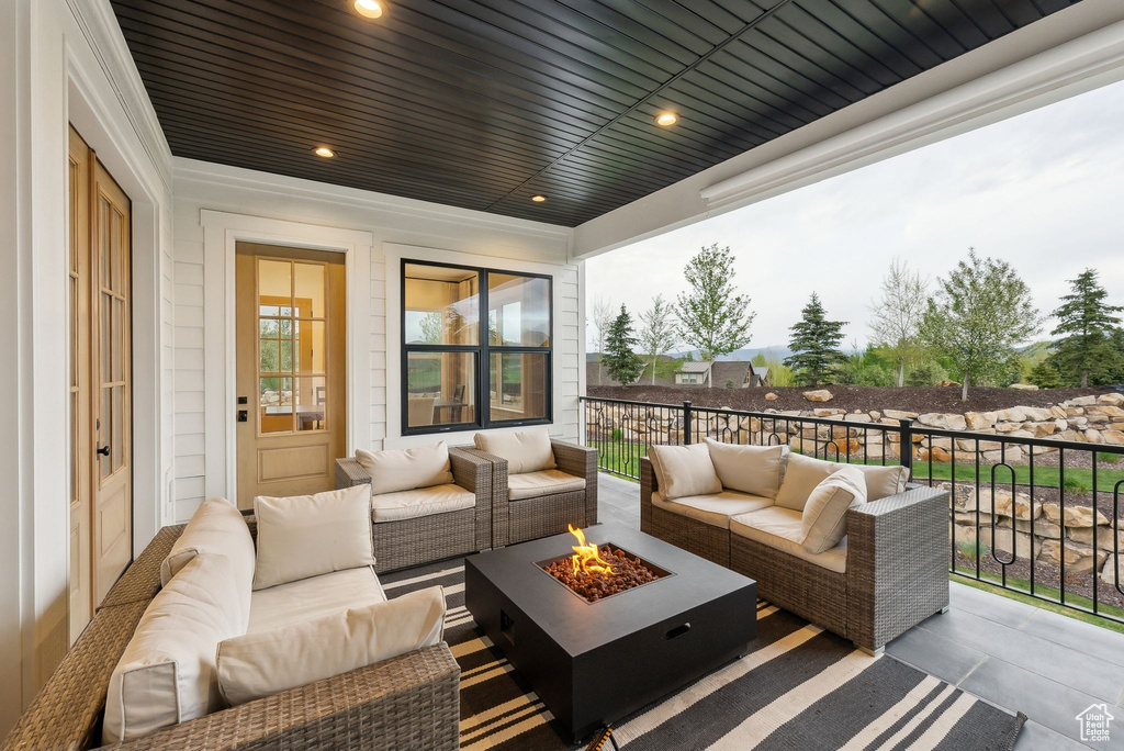 View of patio with an outdoor living space with a fire pit