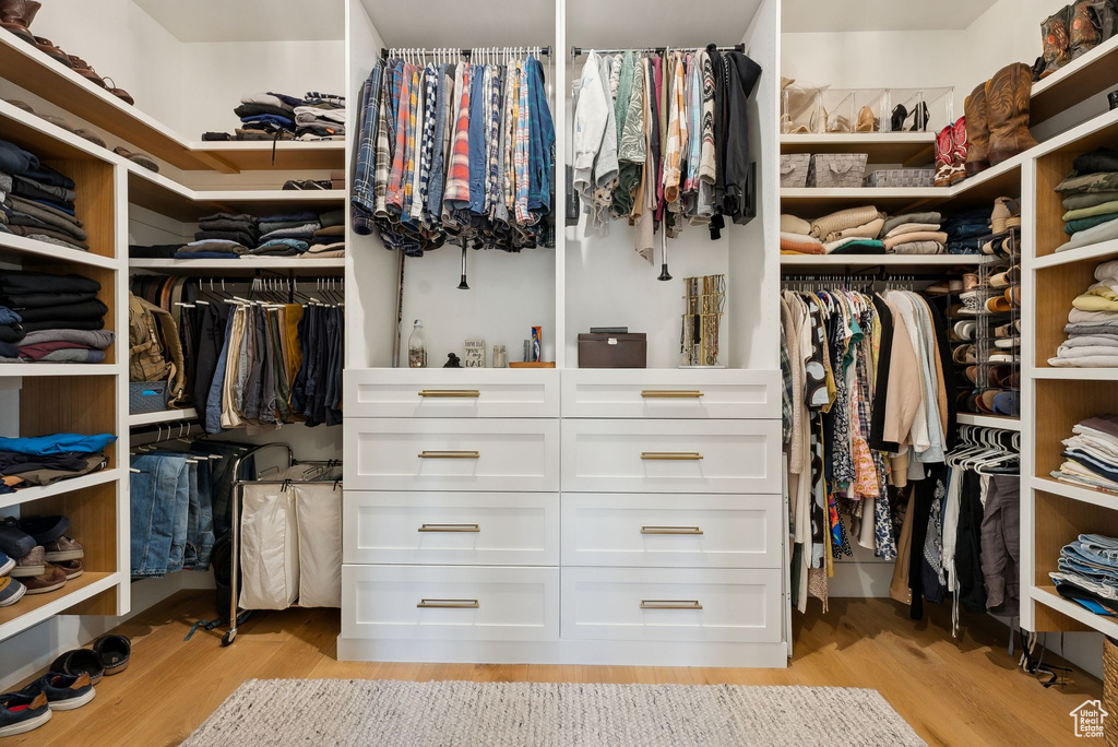 Spacious closet with light wood-style floors