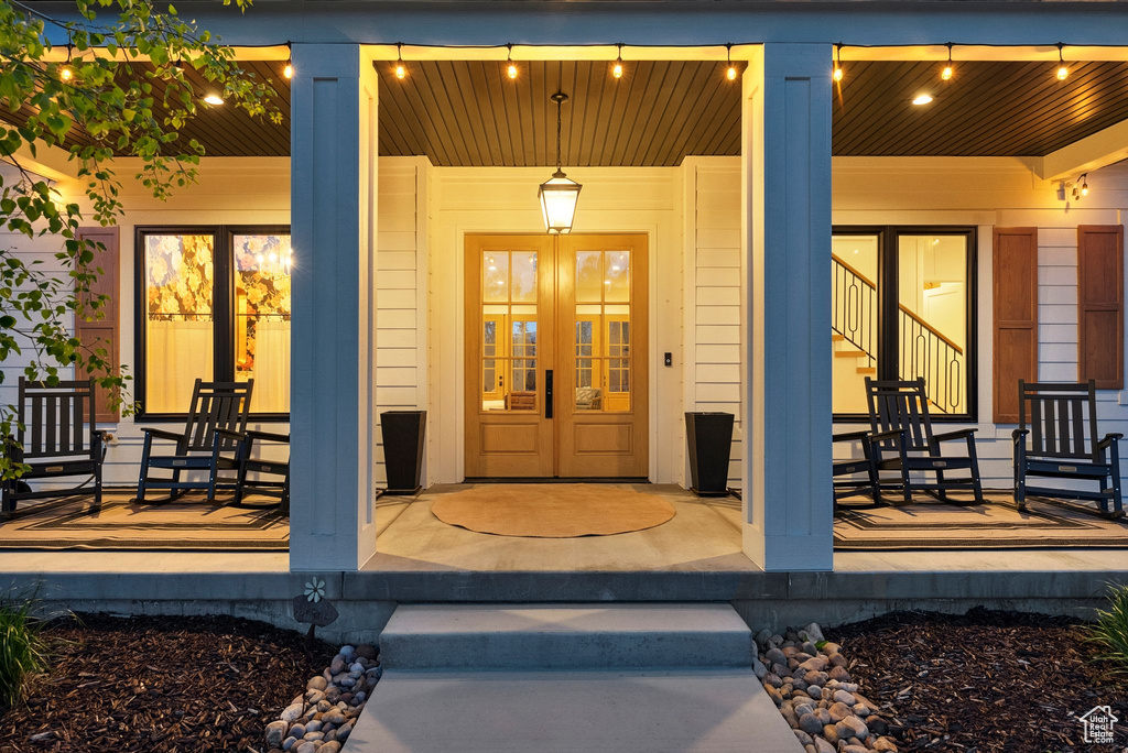 Doorway to property featuring a porch and french doors