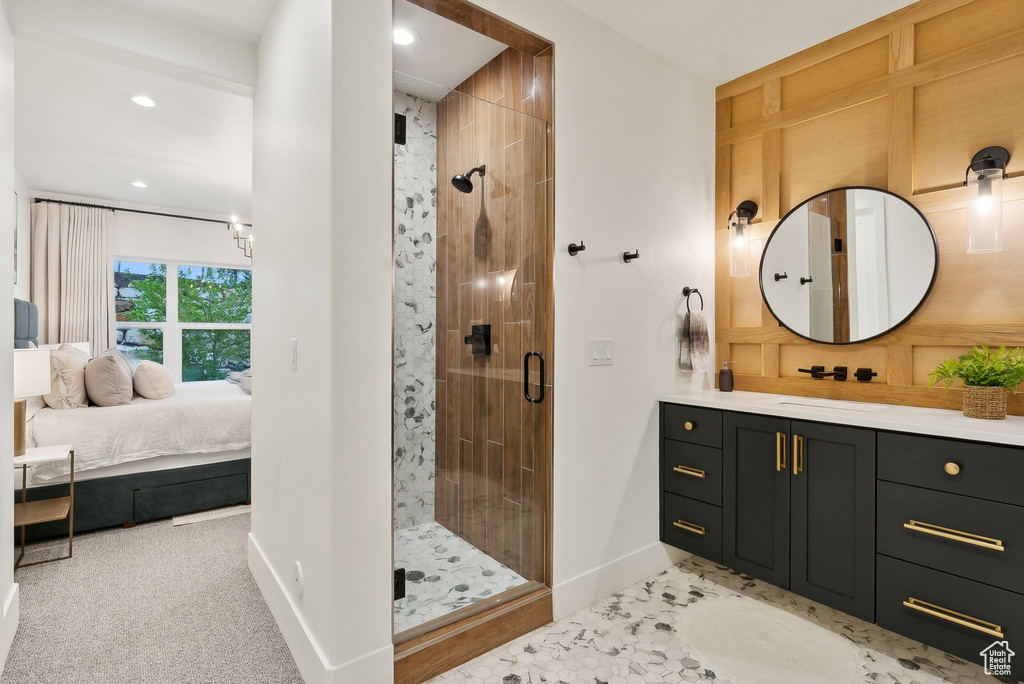 Full bath with ensuite bath, baseboards, a stall shower, recessed lighting, and vanity