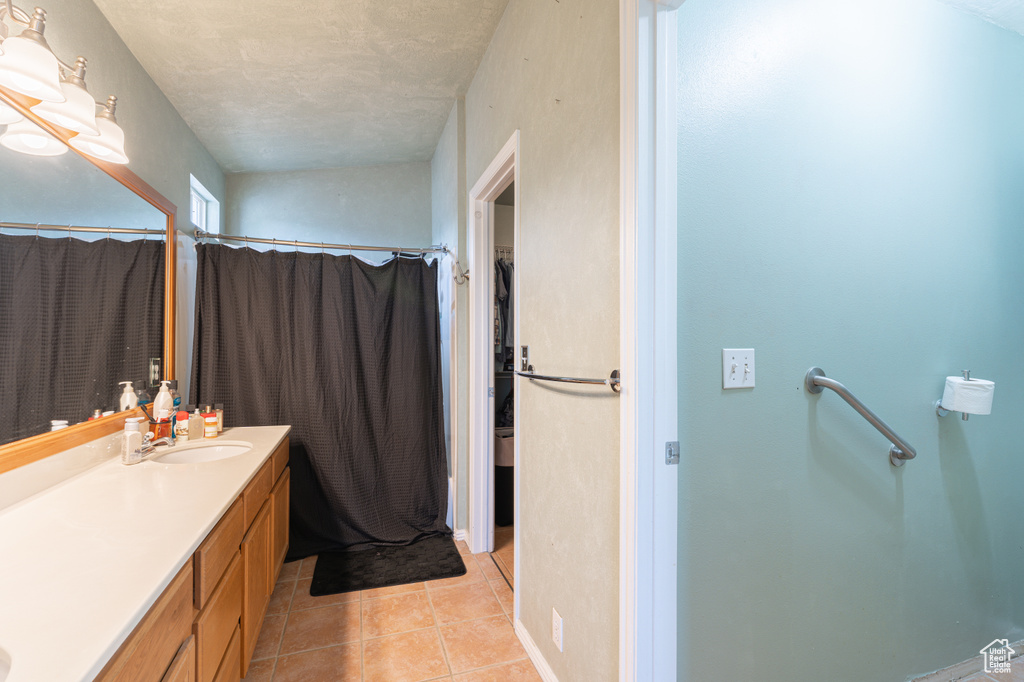 Full bath with vanity, tile patterned floors, and a shower with curtain