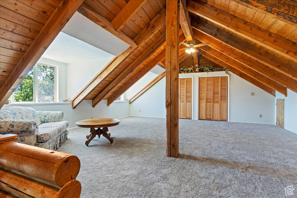 Living room featuring wooden ceiling, carpet, and a ceiling fan