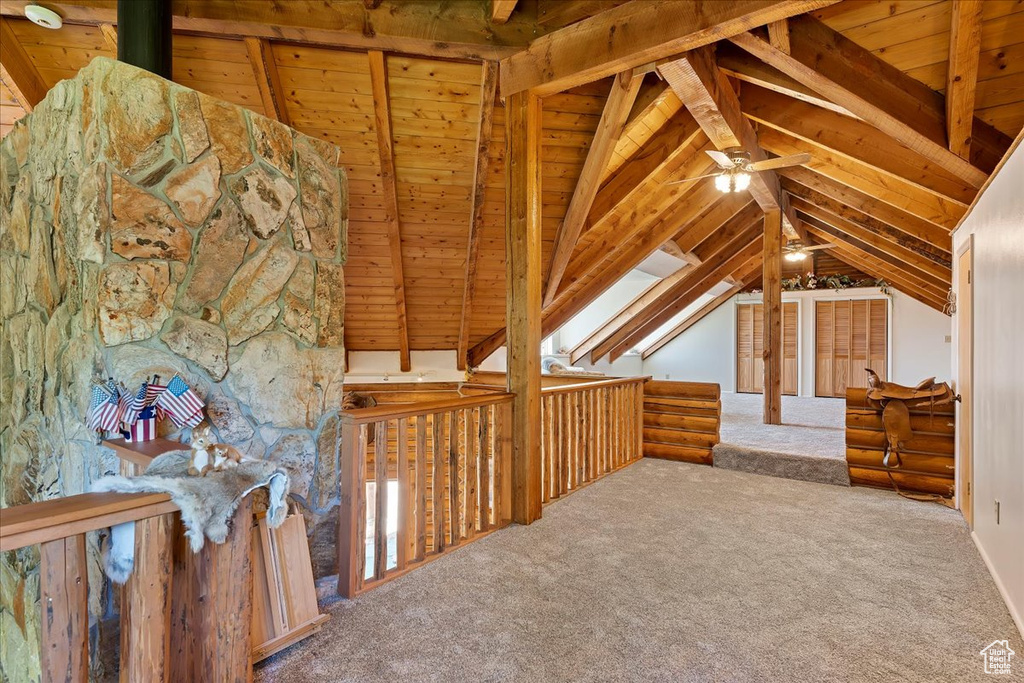 Additional living space featuring a ceiling fan, carpet flooring, and wooden ceiling