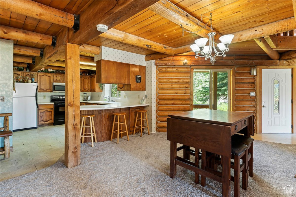 Dining space featuring wooden ceiling, beamed ceiling, a chandelier, rustic walls, and light carpet