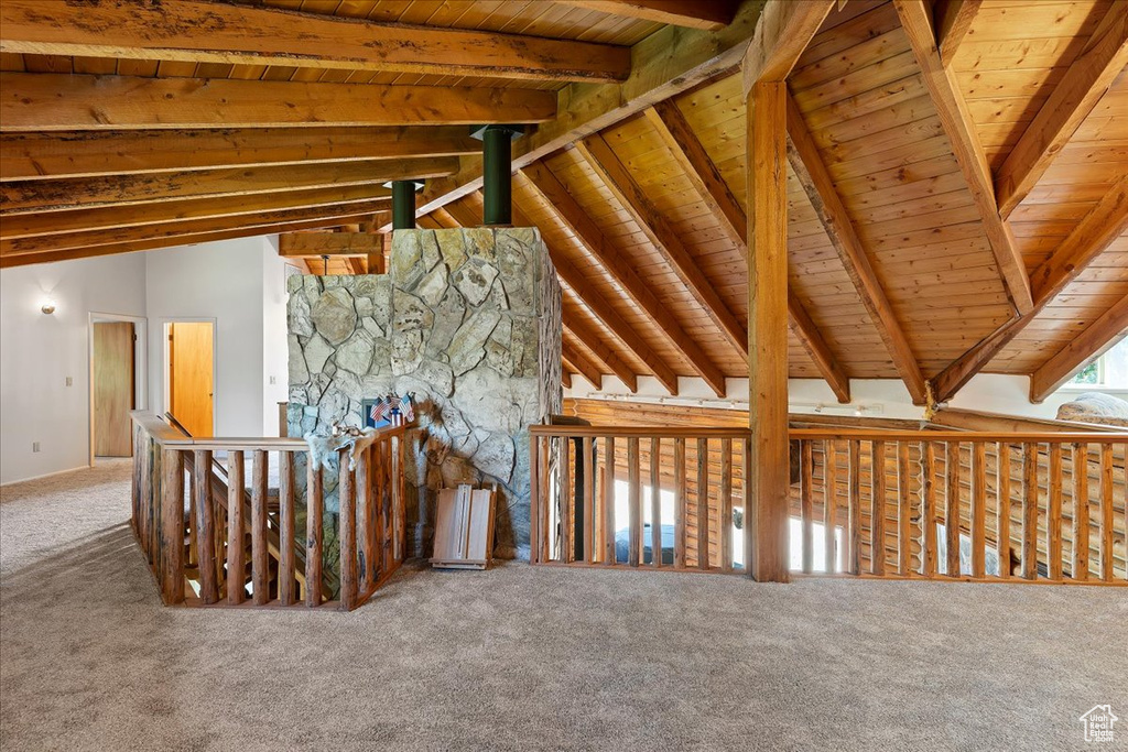 Unfurnished living room featuring carpet floors and wooden ceiling