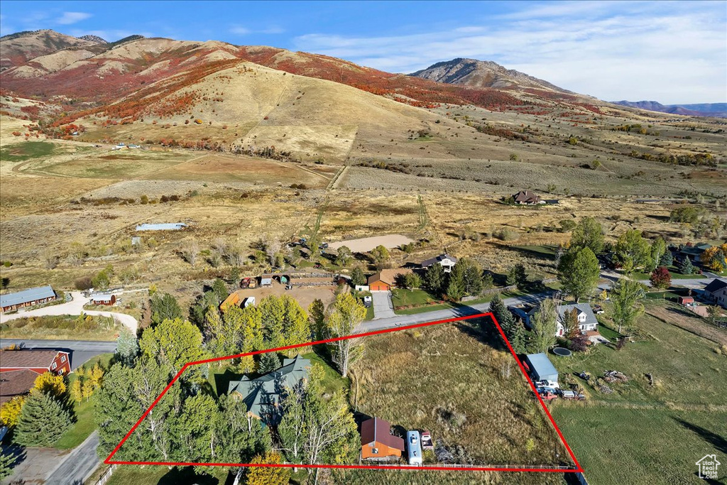 Aerial view of property's location with property parcel outlined and a mountain backdrop