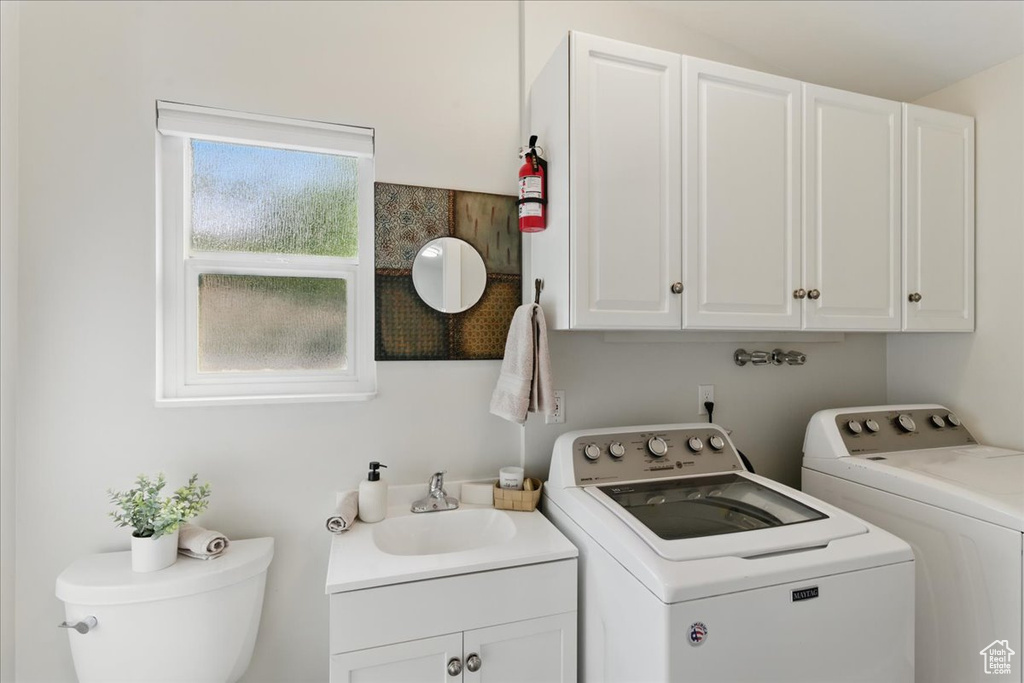 Clothes washing area featuring washing machine and clothes dryer