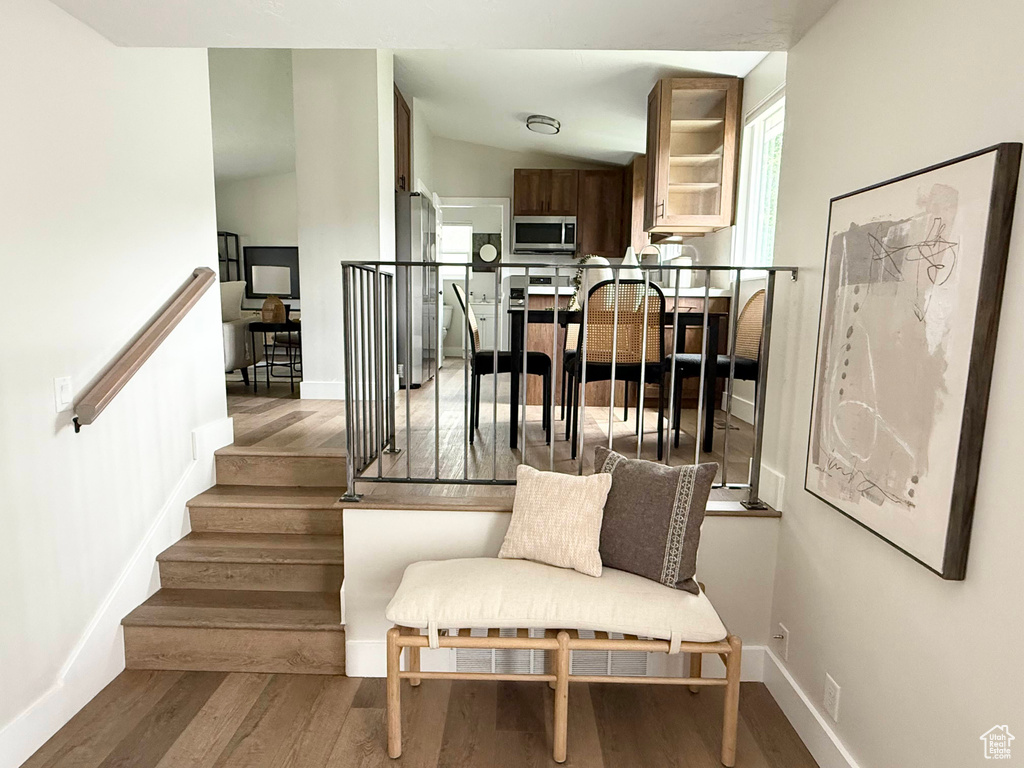 Staircase featuring wood finished floors and baseboards