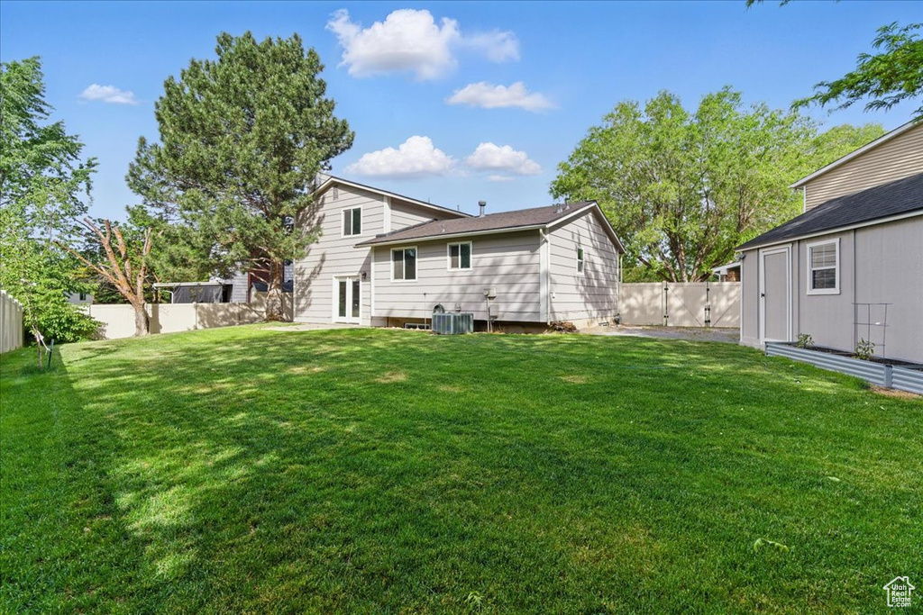 Back of house featuring central air condition unit and french doors