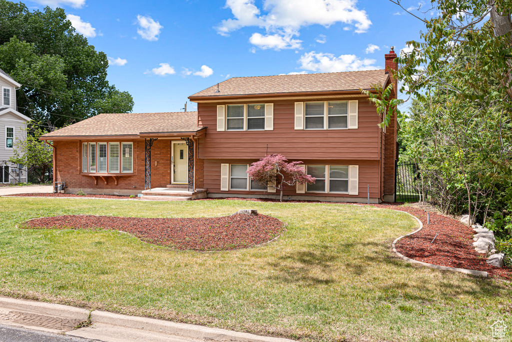 Split level home featuring a chimney