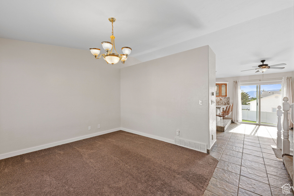 Unfurnished room featuring a chandelier, baseboards, and a ceiling fan