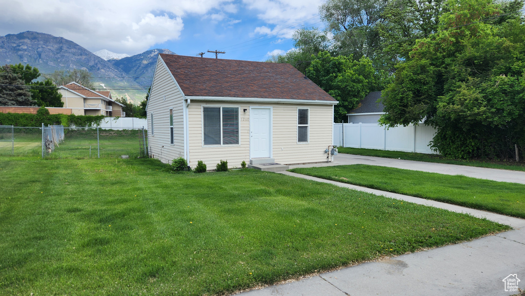 View of front facade with a mountain view and a shingled roof