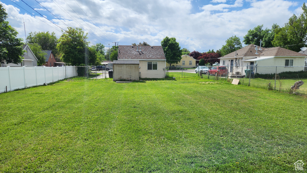 View of yard featuring a storage unit and an outdoor structure