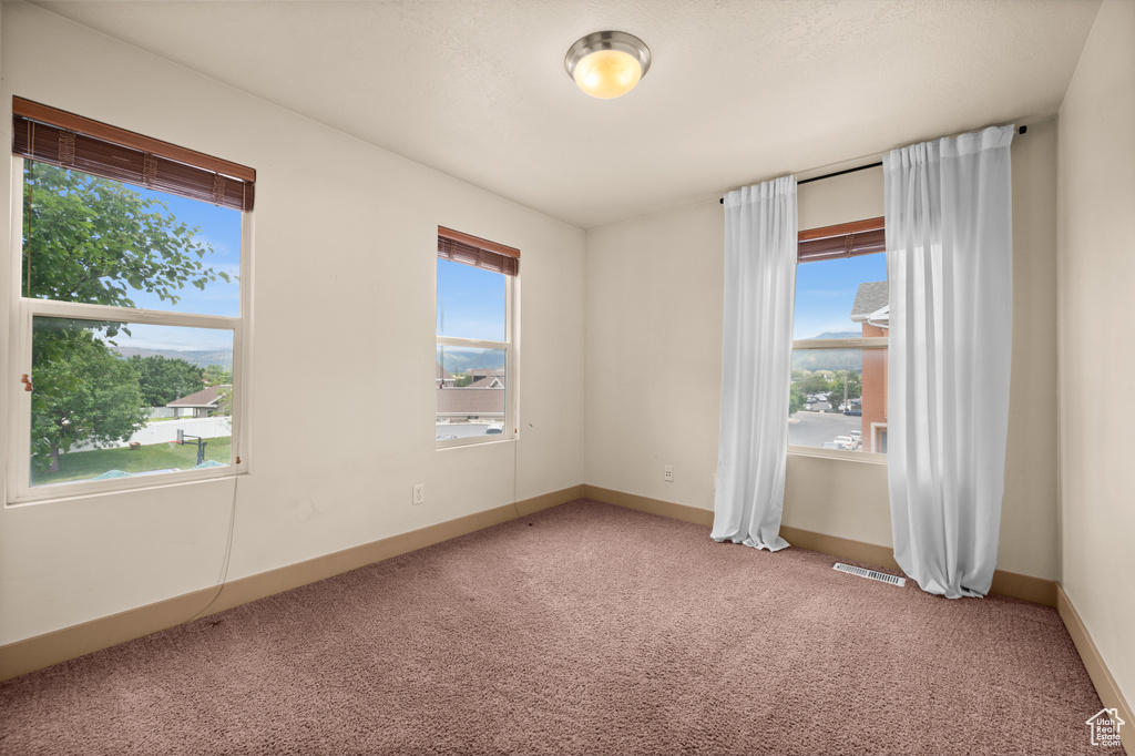 Unfurnished room with carpet flooring and baseboards