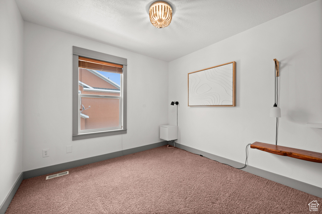 Unfurnished room with carpet and baseboards