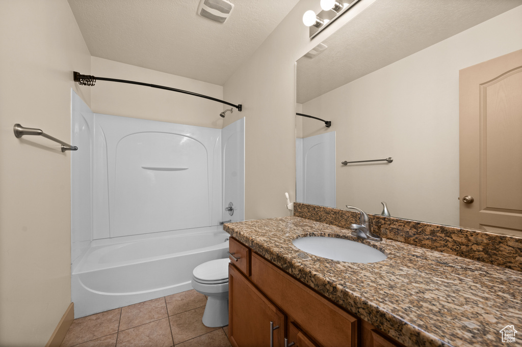 Full bath featuring toilet, vanity,  shower combination, tile patterned floors, and baseboards