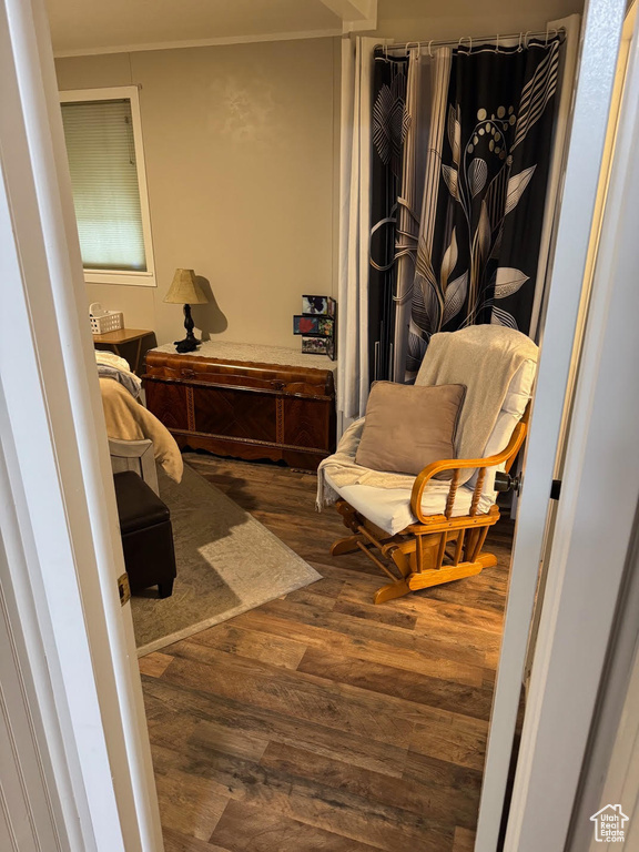 Sitting room featuring wood finished floors and ornamental molding