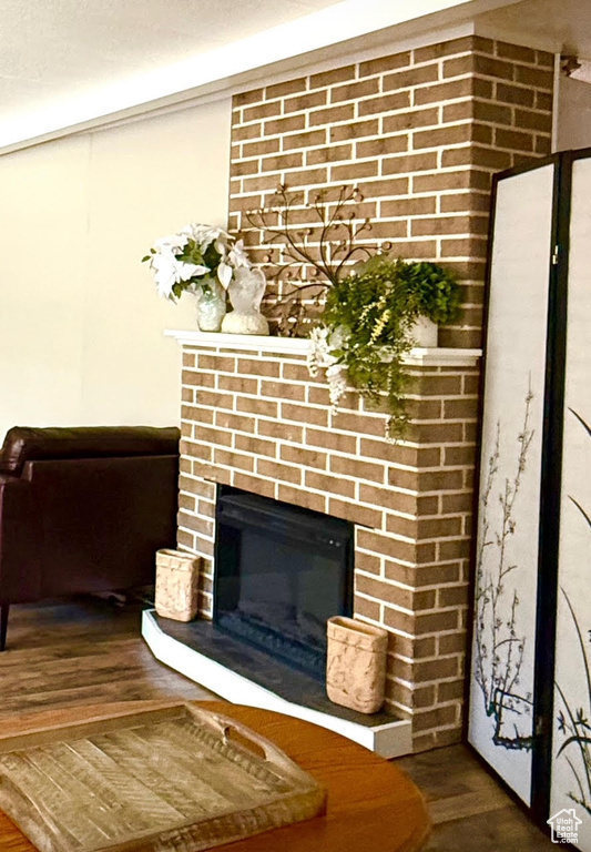 Detailed view of wood finished floors and a fireplace