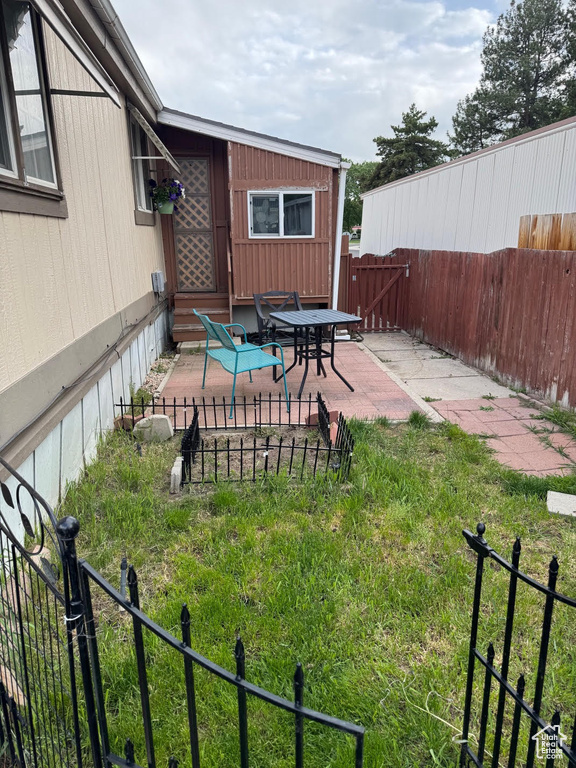 Fenced backyard featuring a patio area and entry steps