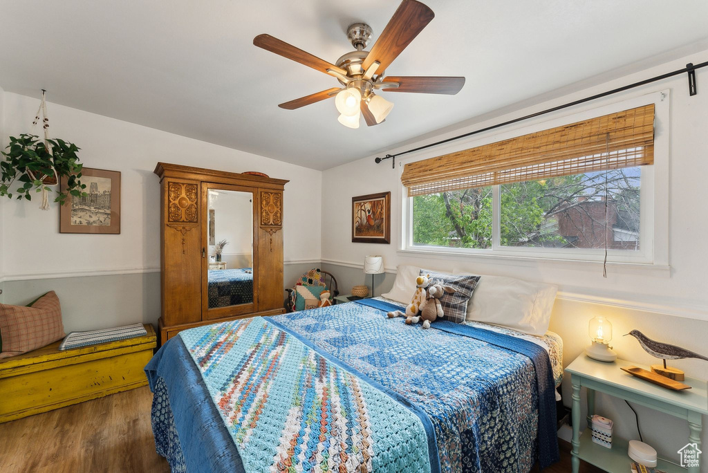 Bedroom featuring wood finished floors, vaulted ceiling, and ceiling fan