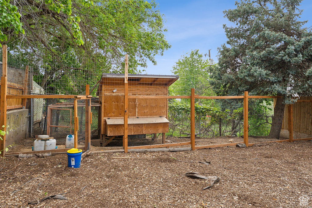 View of yard with exterior structure, an outdoor structure, and fence