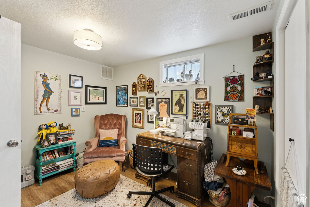 Home office with wood finished floors