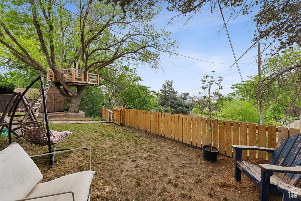 Fenced backyard with a storage unit