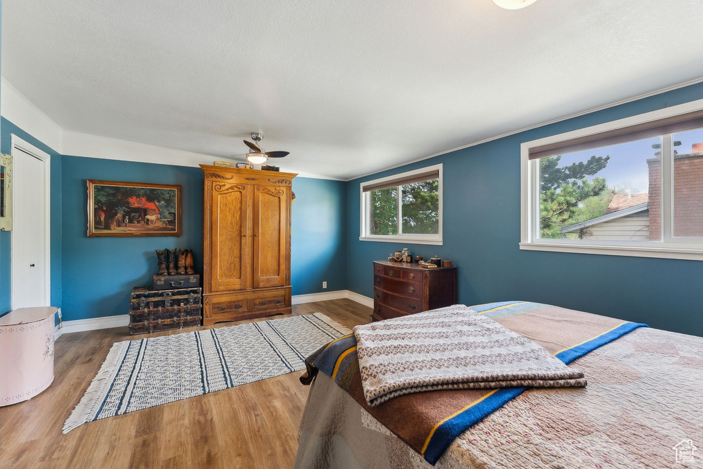 Bedroom with wood finished floors and baseboards