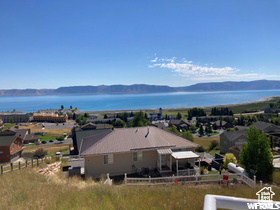 View from above of property with a water and mountain view