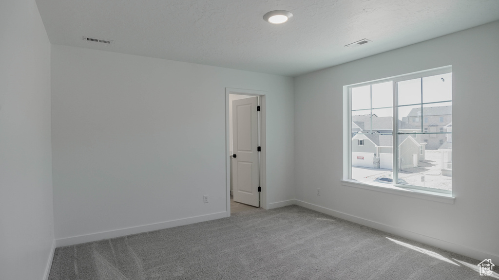 Spare room featuring carpet
