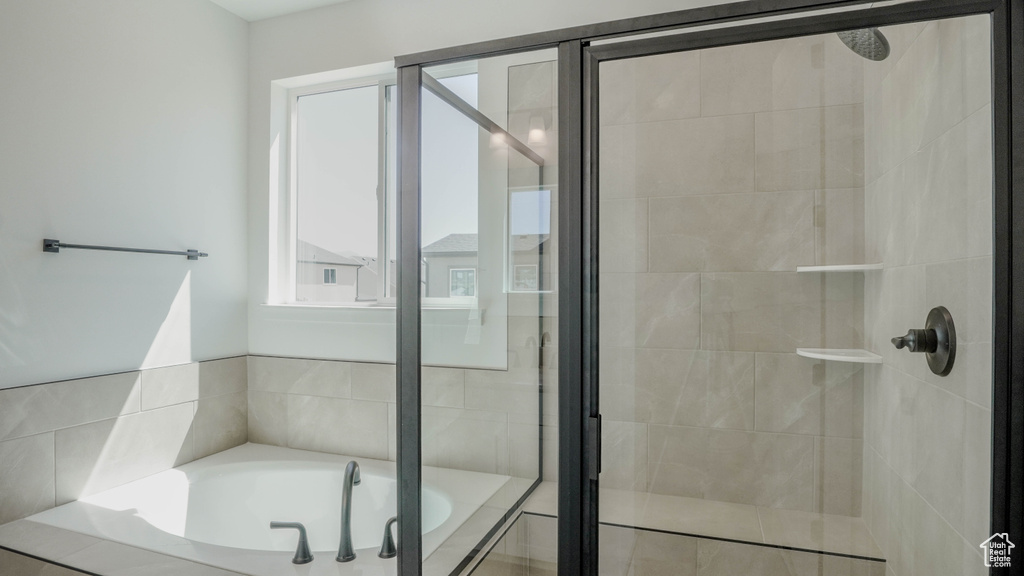 Full bath with a stall shower and a bath