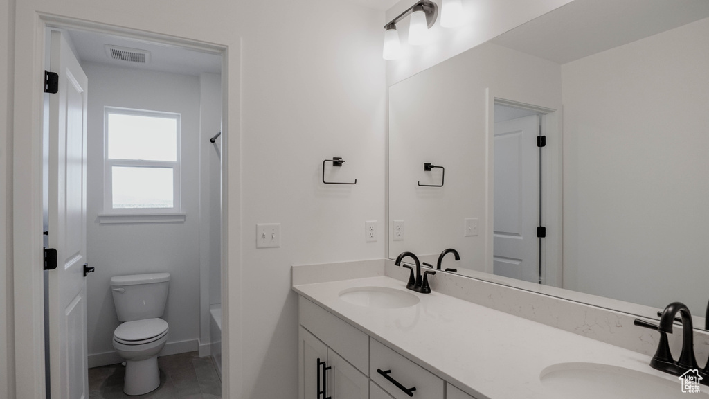Full bathroom with double vanity and shower / washtub combination