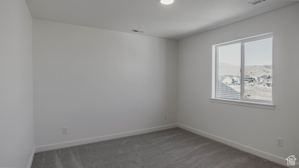 Unfurnished room with carpet floors and baseboards