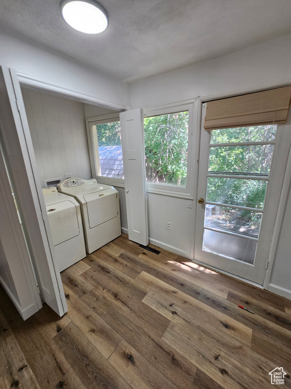 Laundry room with washing machine and dryer and dark wood-style flooring