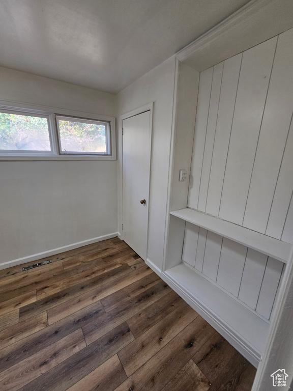 Mudroom with dark wood-style flooring and baseboards