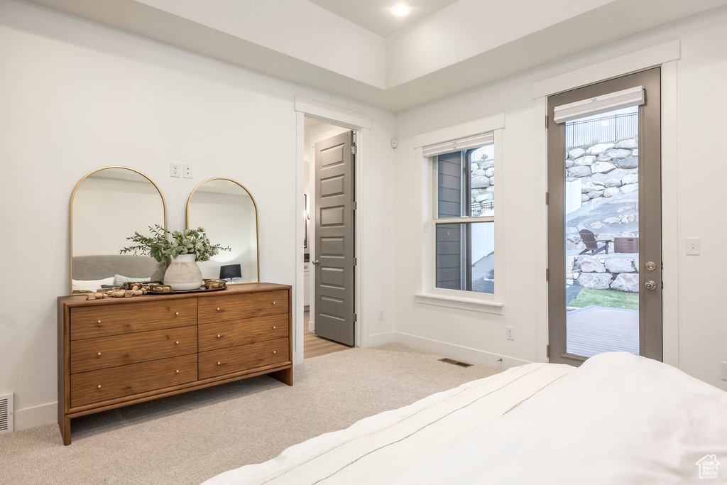 Bedroom with carpet flooring, access to outside, and baseboards