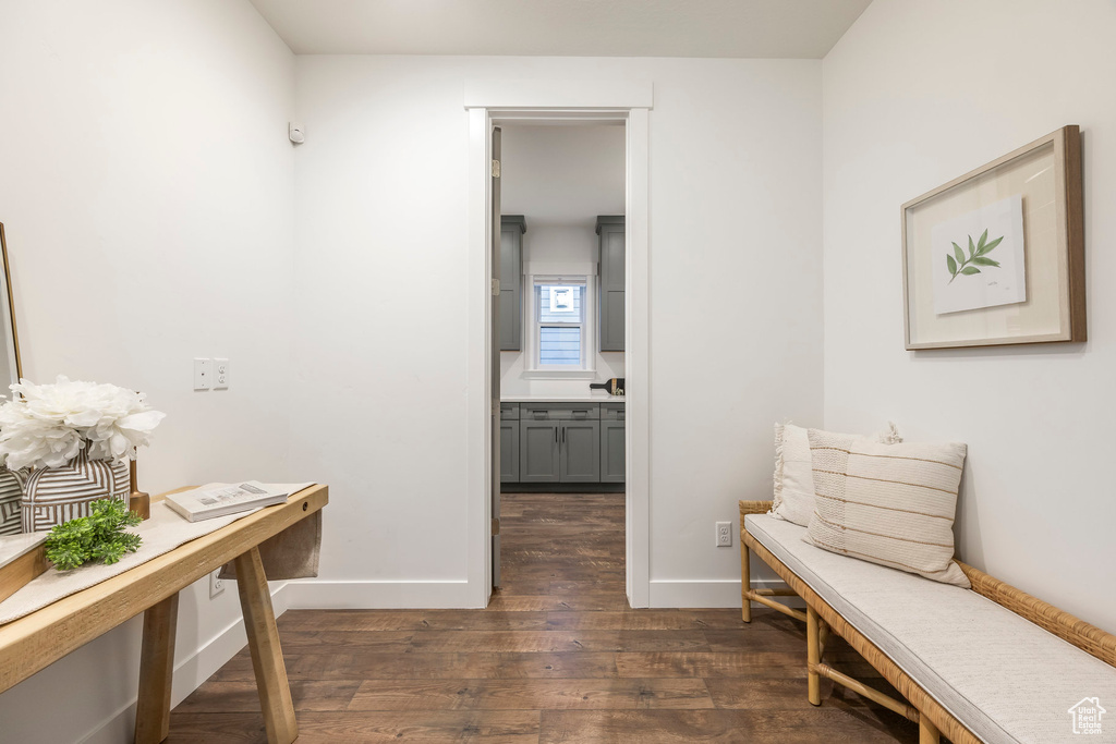 Corridor featuring dark wood-type flooring and baseboards