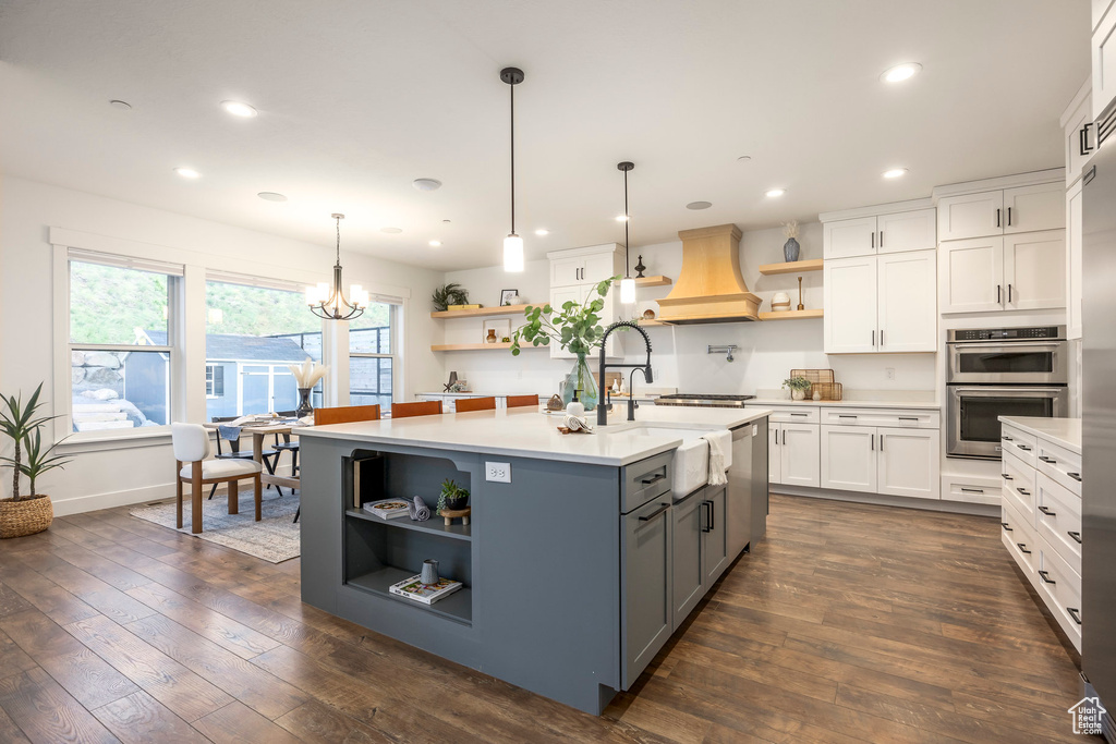 Kitchen with open shelves, gray cabinets, light countertops, appliances with stainless steel finishes, and white cabinets
