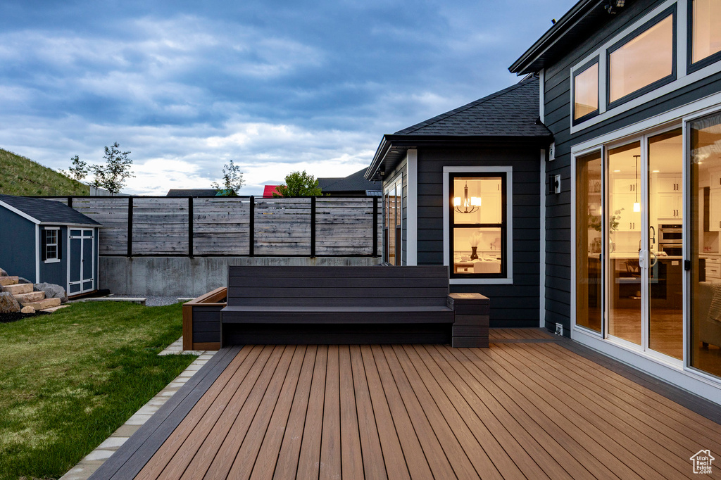 Wooden deck with a storage shed and an outdoor structure