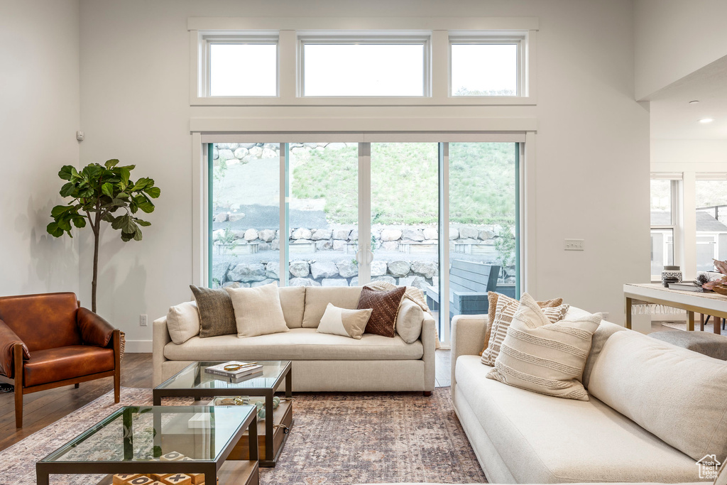 Living room with a towering ceiling and wood finished floors