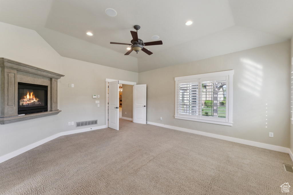Unfurnished bedroom featuring vaulted ceiling, carpet flooring, a high end fireplace, baseboards, and recessed lighting