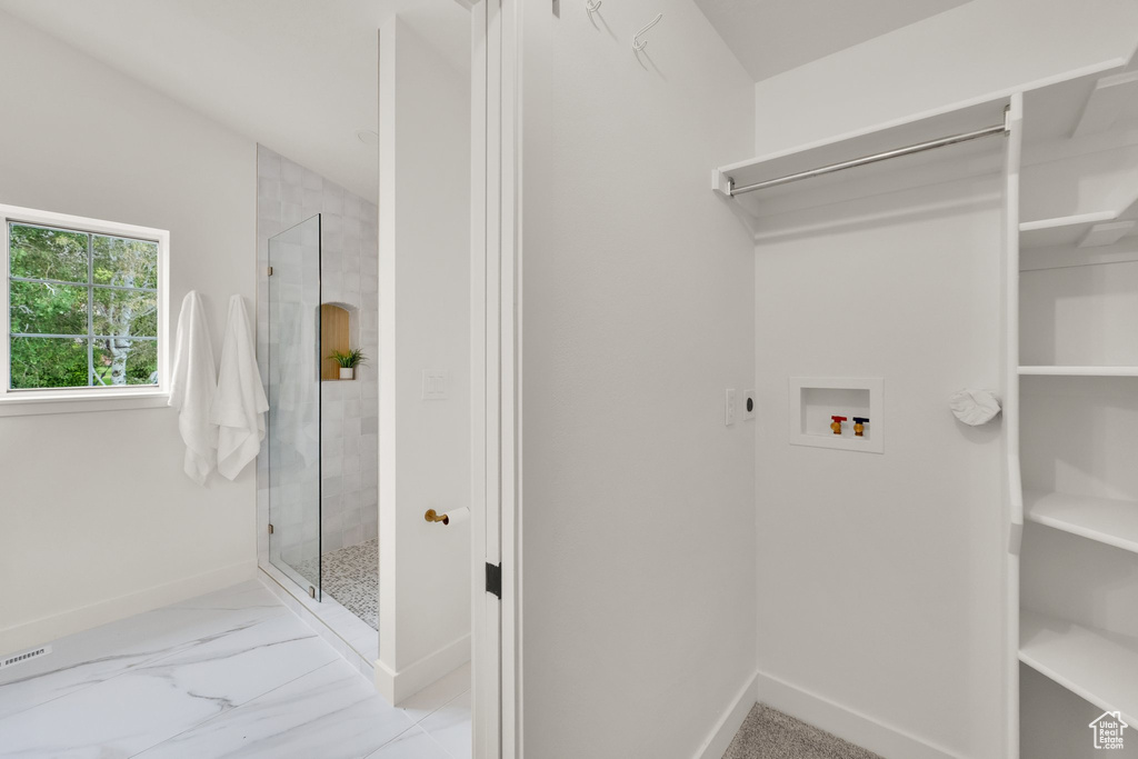 Laundry area featuring washer hookup, hookup for an electric dryer, baseboards, and marble finish floors